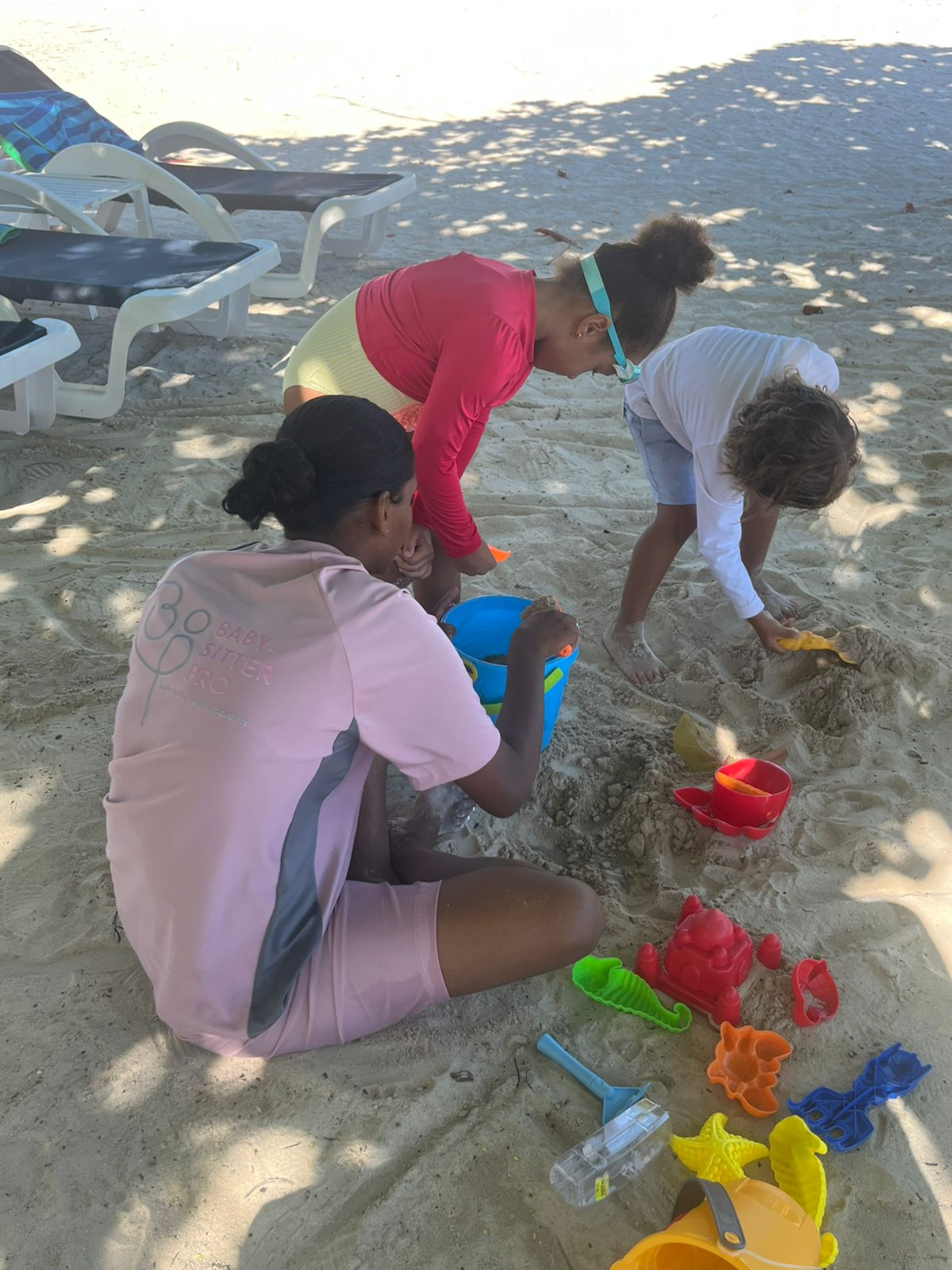 Children playing on the white sand at the shoreline